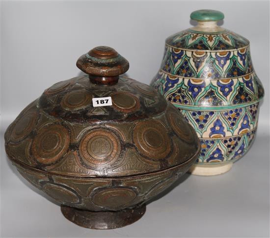 A Moroccan pottery jar and cover and an Islamic wood and metal mounted jar and cover